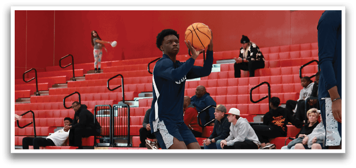 A man is playing basketball in a gym, holding a basketball in his hands. AI generated content