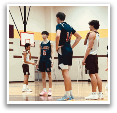 A group of young men playing basketball on a court. AI generated content