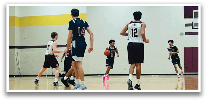 A group of young men playing basketball on a court. AI generated content