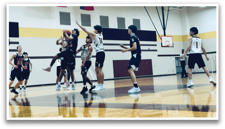 A group of young men playing basketball in a gym. AI generated content