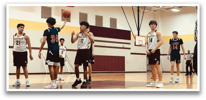 A group of young men playing basketball in a gym. AI generated content