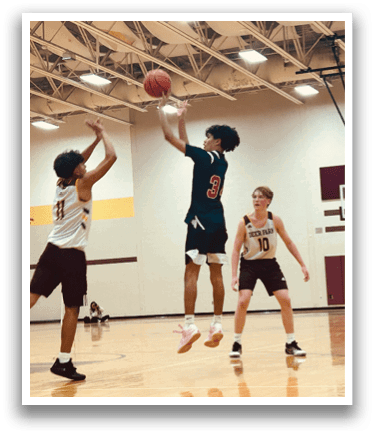 A basketball game is in progress with a player jumping to shoot the ball. AI generated content