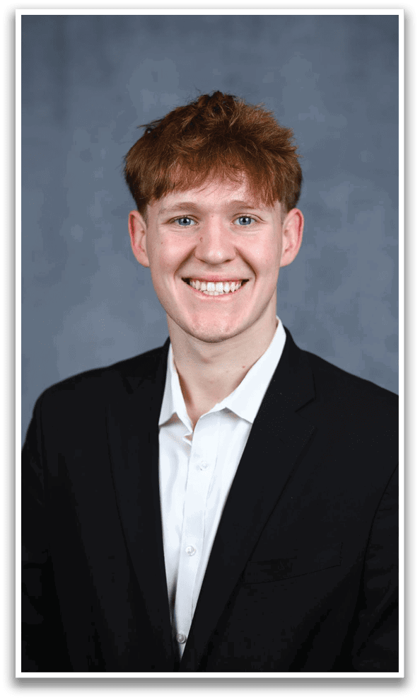 A young man wearing a suit and tie is smiling for the camera. AI generated content