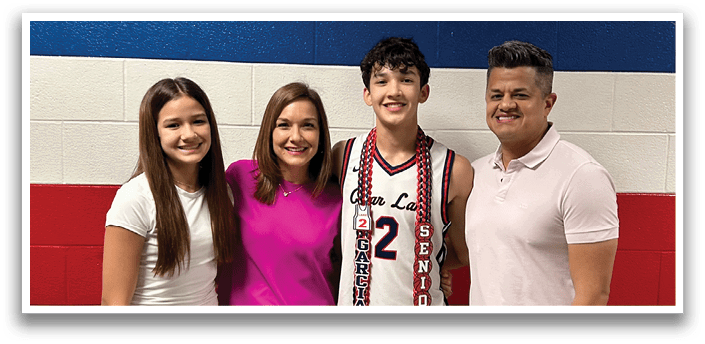 A man wearing a basketball jersey stands between a woman and two children, all posing for a photo. AI generated content