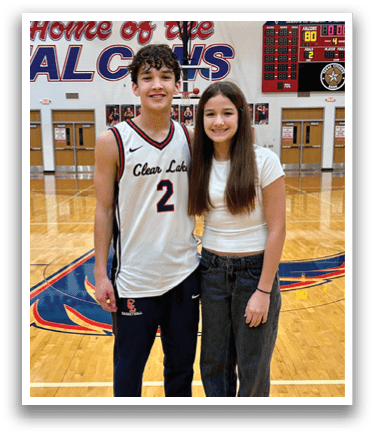 A boy and girl pose for a picture on a basketball court. AI generated content