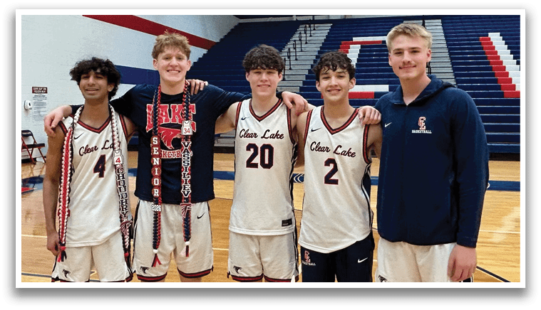 Five basketball players pose for a photo on the court. AI generated content