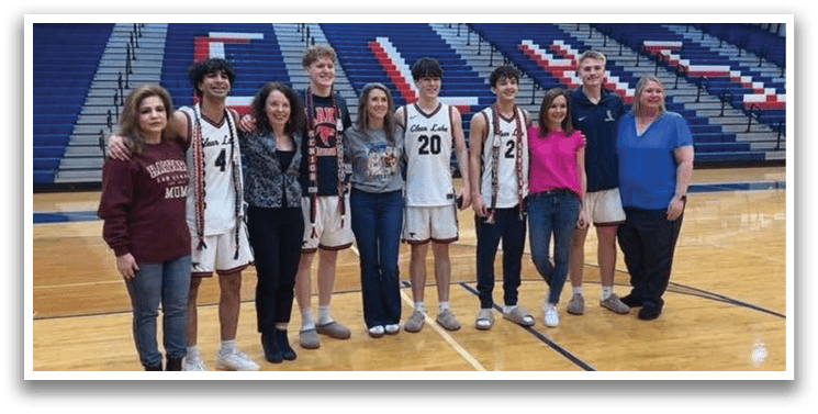 A group of people, including a man wearing a basketball jersey, pose for a photo on a basketball court. AI generated content