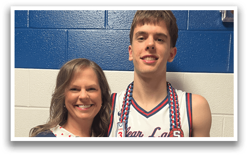 A man wearing a basketball jersey and a woman wearing a blue shirt pose for a picture. AI generated content