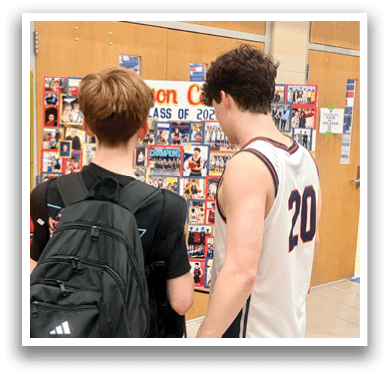 Two young men wearing basketball uniforms are standing in front of a bulletin board. AI generated content