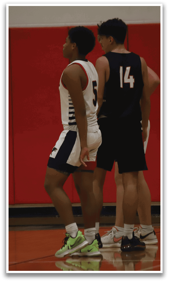 Two people are standing on a basketball court, one wearing a white uniform and the other wearing a black uniform. They are both holding their hands on their hips. AI generated content