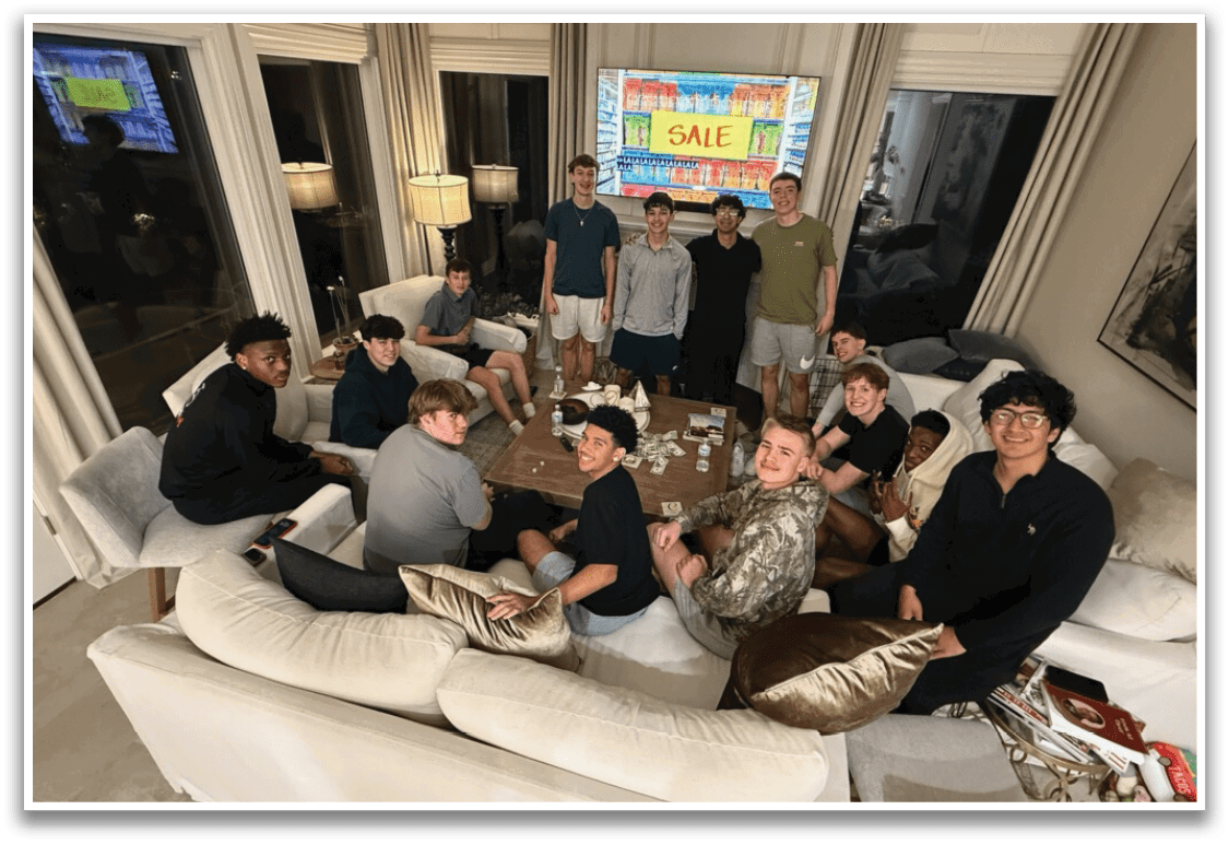 A group of young men are sitting on a couch in a living room. They are posing for a picture in front of a large TV. AI generated content