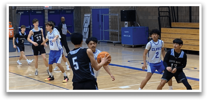 A group of young men playing basketball in a gym. AI generated content