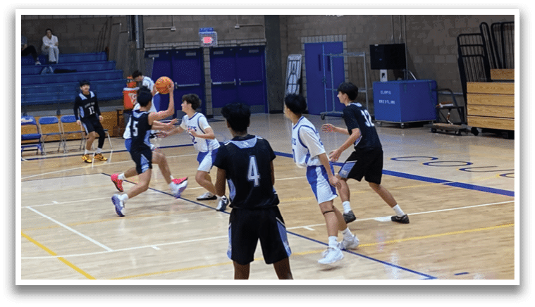 A basketball game is taking place in a gymnasium with a group of people playing. The court is surrounded by a crowd of spectators. AI generated content