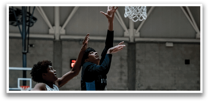 Two men are playing basketball, one of them jumping to catch the ball. AI generated content