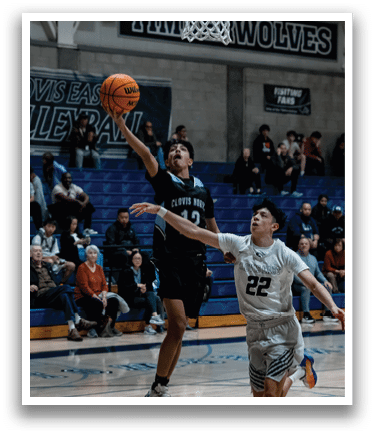 Two men are playing basketball, one of them is jumping to catch the ball. AI generated content