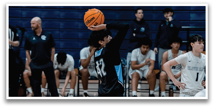 A man is holding a basketball in a gym. AI generated content