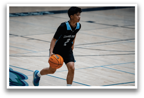 A boy in a basketball uniform is holding a basketball. AI generated content