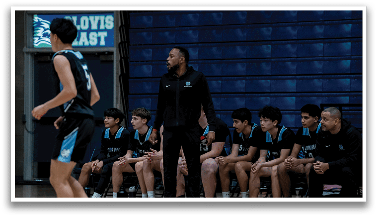 A group of people are sitting on a bench, watching a basketball game. AI generated content