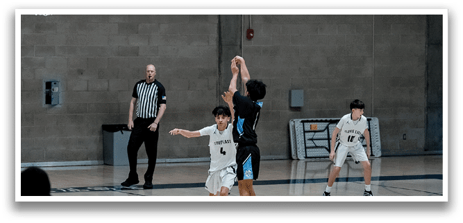 A group of young men playing basketball in a gym. AI generated content