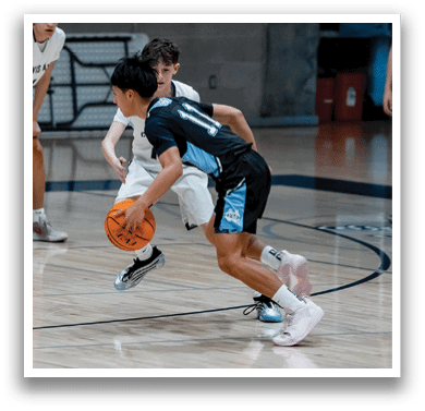 A group of young men playing basketball on a court. AI generated content