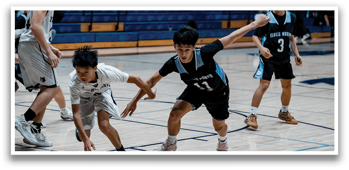 A group of young men playing basketball on a court. AI generated content