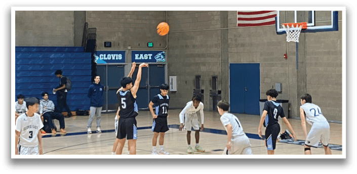 A group of young men playing basketball in a gym. AI generated content