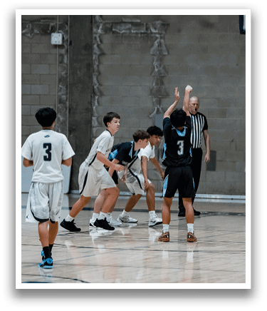 A group of young men playing basketball on a court. AI generated content