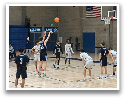 A group of young men playing basketball on a court. AI generated content