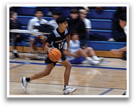 Two boys playing basketball on a court. One boy is holding a basketball and running towards the other boy. AI generated content
