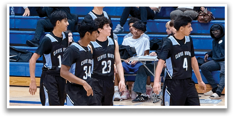 A group of young men playing basketball on a court. AI generated content