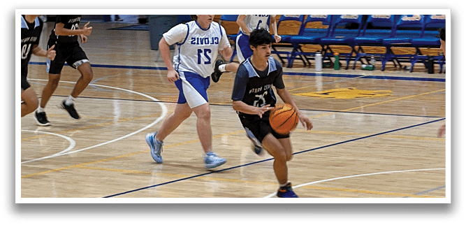 A group of young men playing basketball on a court. AI generated content