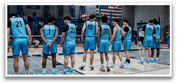 A group of young men wearing blue uniforms are standing on a basketball court. AI generated content