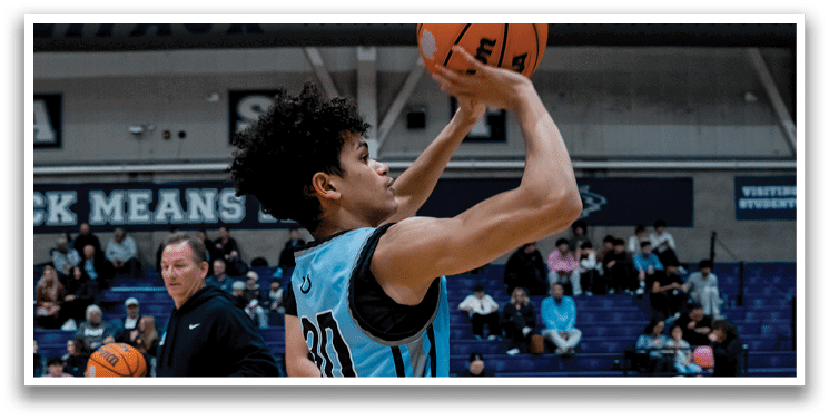 A basketball player wearing a blue shirt and number 4 jersey is holding a basketball in his hands, preparing to shoot it. AI generated content