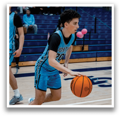 A boy in a blue basketball uniform is holding a basketball on a court. AI generated content