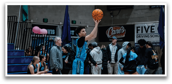 A man in a blue shirt and black shorts is jumping to catch a basketball. AI generated content