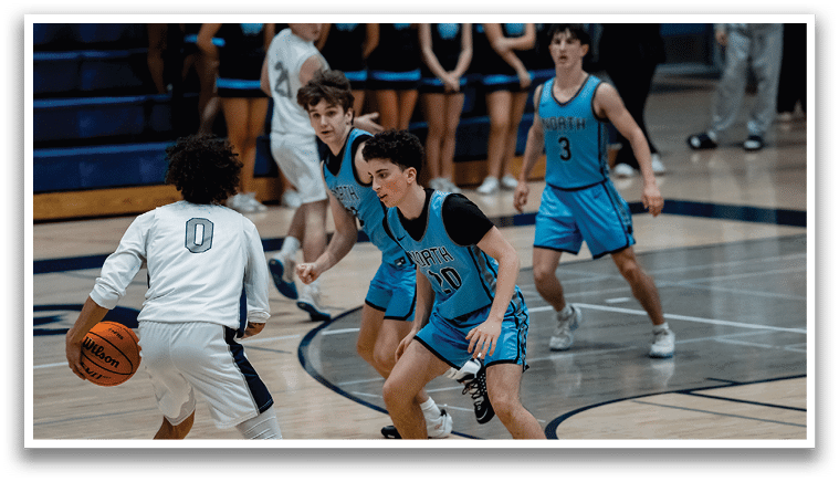 A group of young men playing basketball on a court. AI generated content