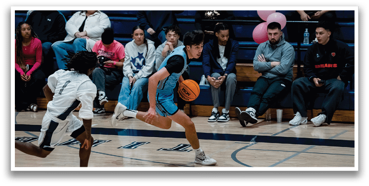 A basketball game is taking place with a man in a blue shirt running with a basketball. AI generated content