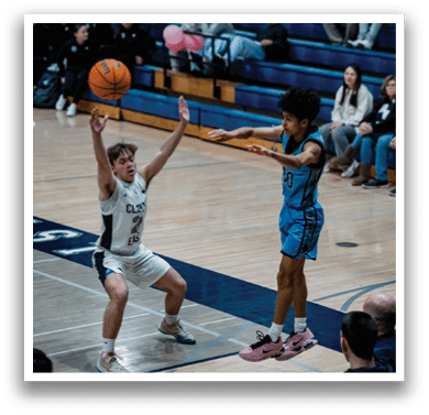Two men playing basketball on a court, one of them jumping to block a shot. AI generated content