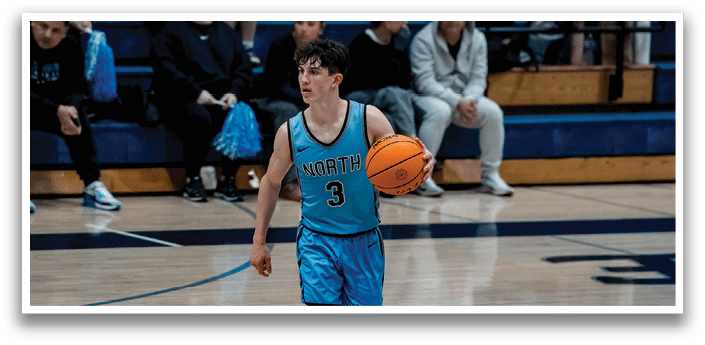 A young man wearing a blue shirt and shorts is holding a basketball. AI generated content