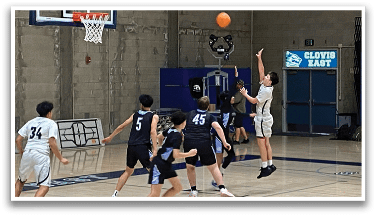 A group of young men playing basketball in a gym. AI generated content