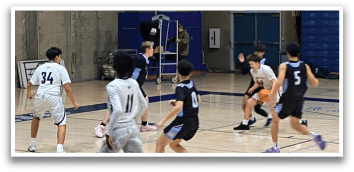 A group of young boys playing basketball on a court. AI generated content