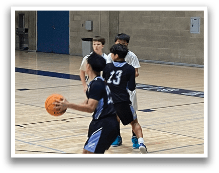 A group of young men playing basketball on a court. AI generated content