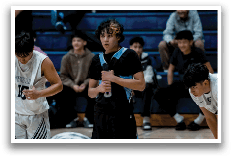 A boy wearing a black shirt and shorts is holding a microphone. AI generated content
