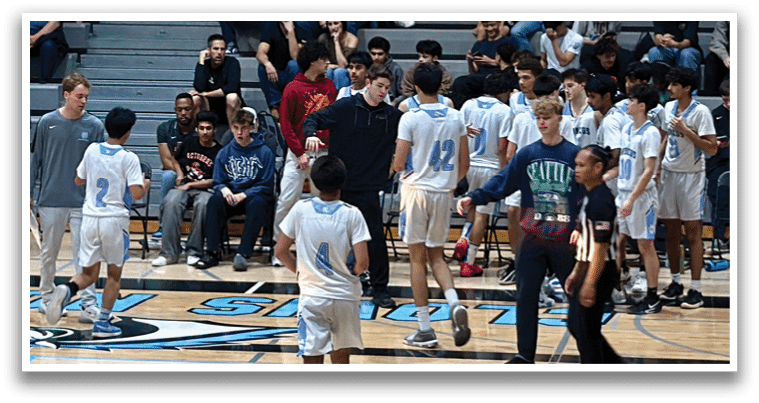 A group of people are standing on a basketball court, some of them wearing uniforms. The crowd is watching the game, and there are several chairs placed around the court. AI generated content