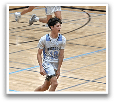 A group of young men playing basketball on a court. AI generated content