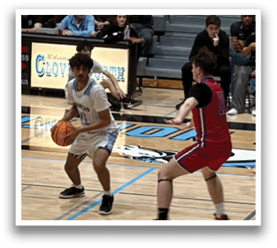 A group of young men playing basketball on a court. AI generated content