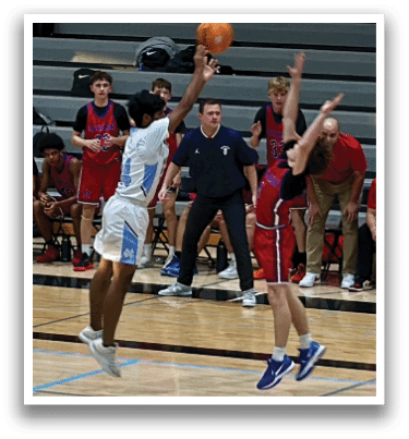 A group of people are playing basketball on a court. One person is jumping to catch the ball while others watch. AI generated content