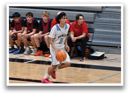 A boy in a blue shirt is running with a basketball. AI generated content