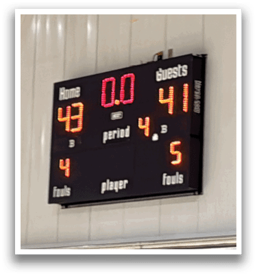 A scoreboard in a gym shows the score of a basketball game. AI generated content