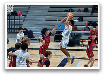 A group of young men playing basketball, with one player jumping to block a shot. AI generated content